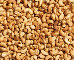 Roasted cashew nuts, texture and background . Tasty cashew nuts as background,cashew nuts texture. flat lay